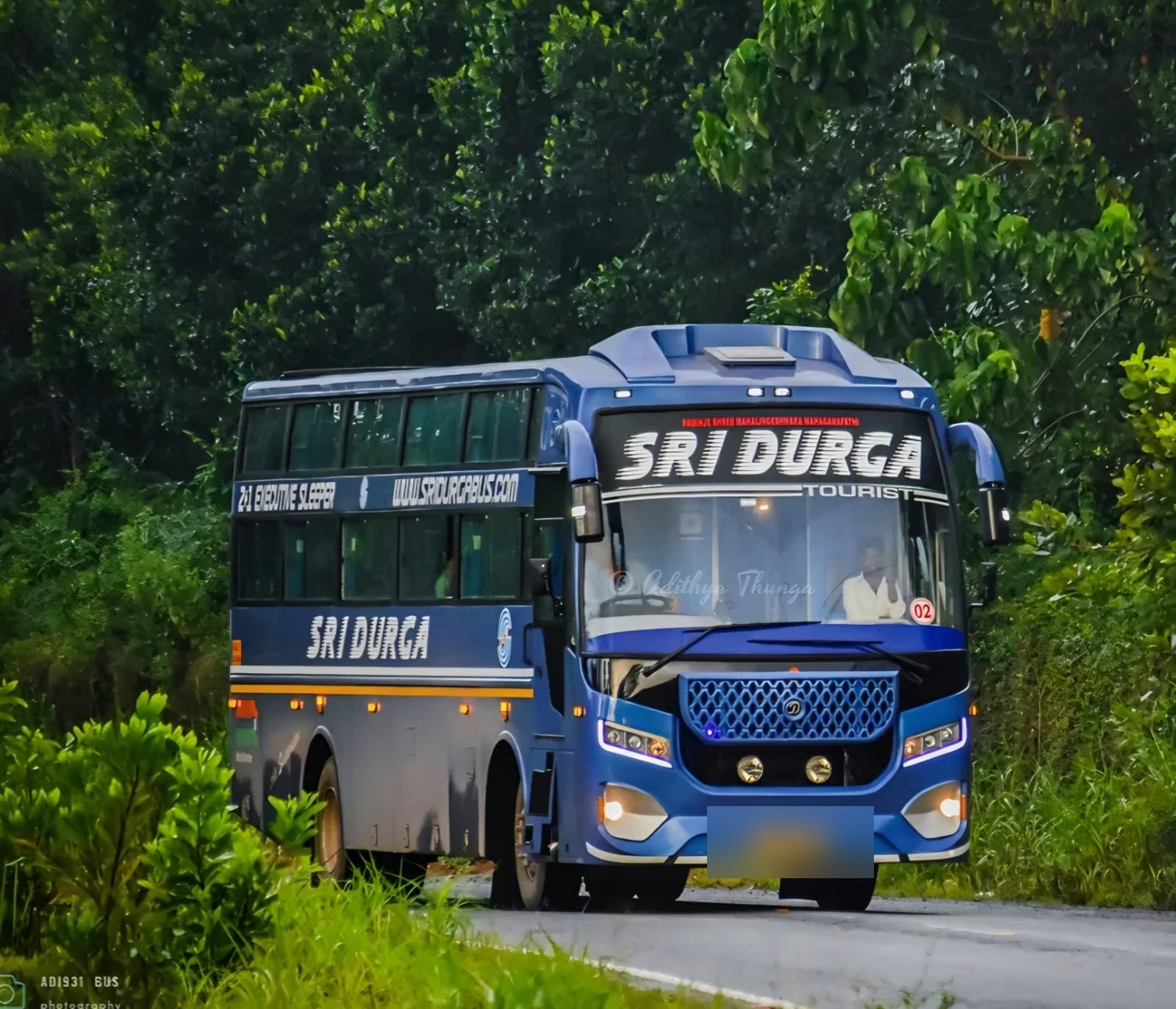 Sri Durga Tourist bus on green forest road